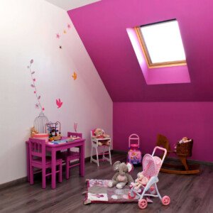 Chambre d’enfant sous combles rose à Saint-Soupplets – un espace lumineux et ludique signé Moreno Création. Chambre d’enfant sous combles à Saint-Soupplets avec coin jeux, parquet et fenêtre Velux – Moreno Création