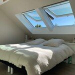 Chambre parentale sous combles à Serris – un espace lumineux et apaisant signé Moreno Création. Chambre parentale aménagée sous combles à Serris avec fenêtres Velux et isolation soignée – Moreno Création